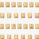 Gold letter blocks spelling out the alphabet on a white background