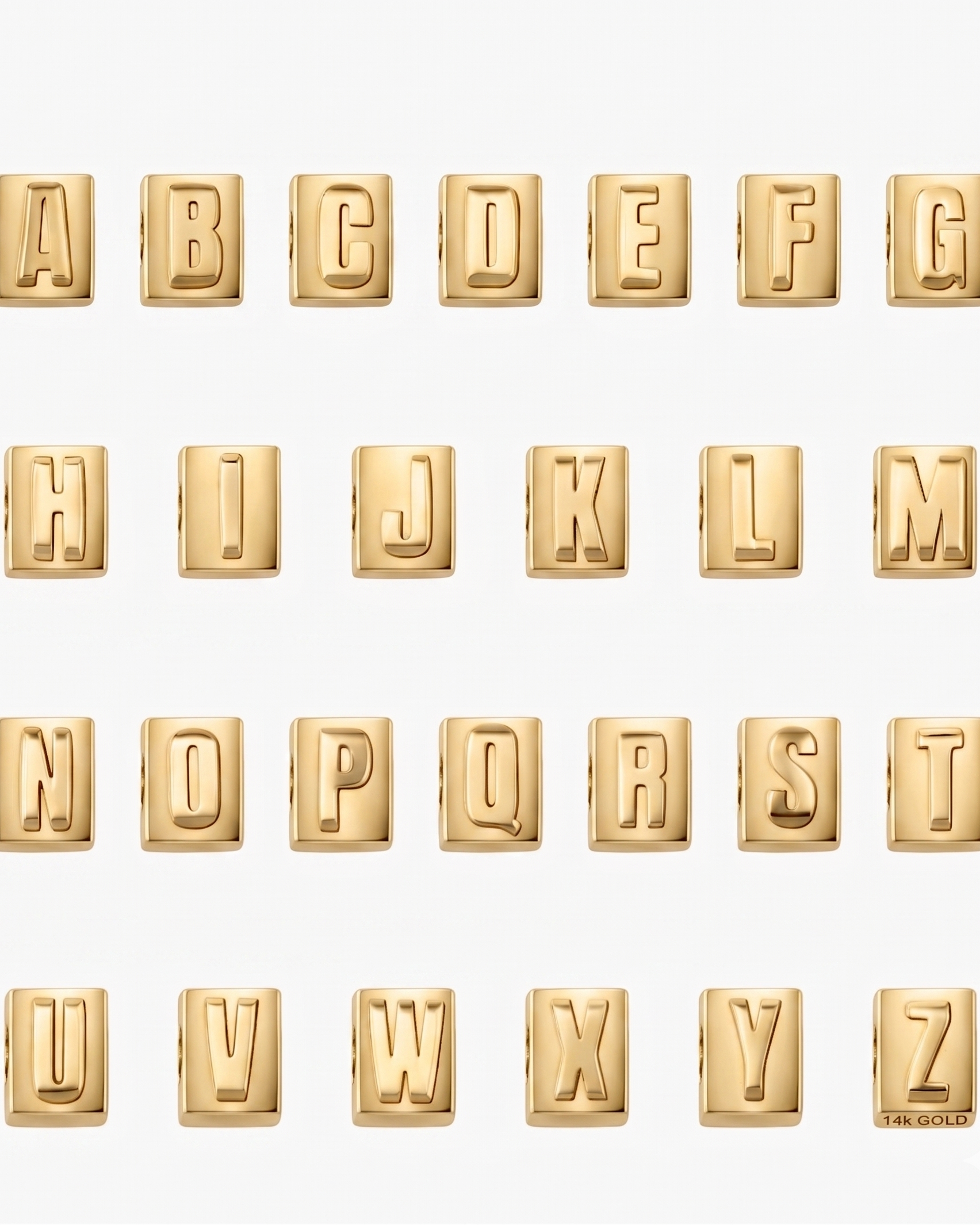 Gold letter blocks spelling out the alphabet on a white background